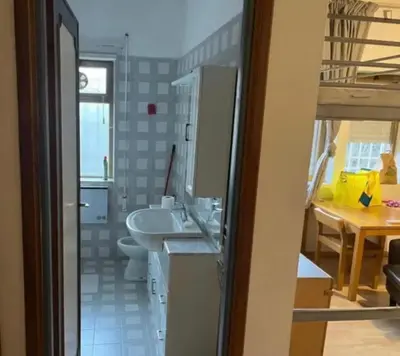 a bathroom with a tub and a sink and a toilet at nel cuore di Roma monolocale con piscina in Rome
