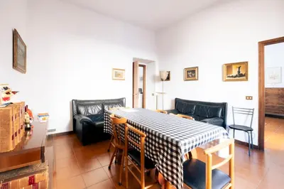a living room with a table and chairs and a couch at A casa da Giordi in Rome