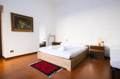 a bedroom with a bed and a painting on the wall at A casa da Giordi in Rome