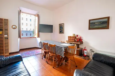 a living room with a table and chairs at A casa da Giordi in Rome