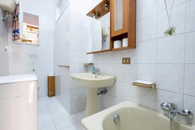 a white bathroom with a sink and a toilet at A casa da Giordi in Rome