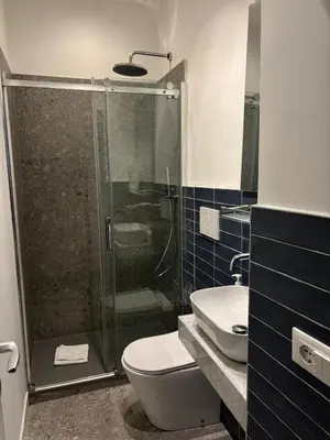a bathroom with a shower and a toilet and a sink at Harmony in Rome ll in Rome