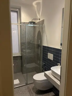a bathroom with a shower and a toilet and a sink at Harmony in Rome ll in Rome