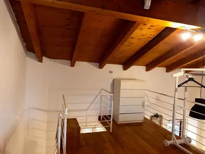 a room with wooden ceilings and a wooden floor at Casa di Nia Pietralata in Rome