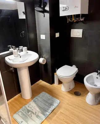 a bathroom with a sink and a toilet at Casa di Nia Pietralata in Rome