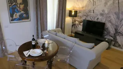 a living room with a white couch and a table at Scipioni245 Charme Apartment in Rome