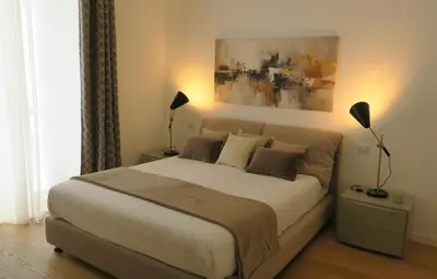 a bedroom with a large bed and a painting on the wall at Scipioni245 Charme Apartment in Rome