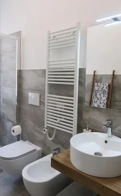 a bathroom with a white sink and a toilet at Scipioni245 Charme Apartment in Rome