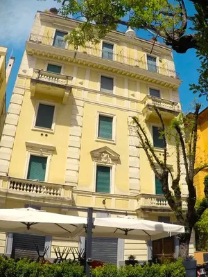 a yellow building with umbrellas in front of it at Scipioni245 Charme Apartment in Rome