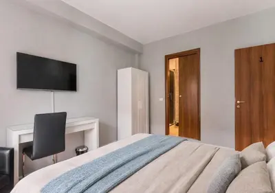 a bedroom with a bed and a television on the wall at Tollì in Rome