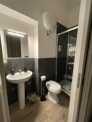 a bathroom with a sink and a toilet and a shower at Rome Groove Rooms in Rome