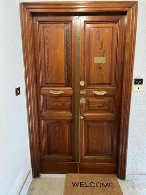 a wooden door with a welcome sign in front of it at Rome Groove Rooms in Rome