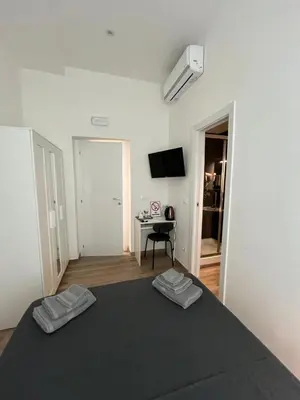 a bedroom with a bed with two towels on it at Rome Groove Rooms in Rome