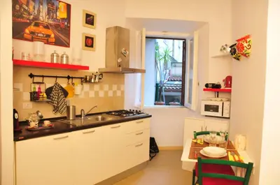 a small kitchen with a sink and a window at CARDINAL STUDIO - 2 steps from Vatican & Ottaviano metro in Rome