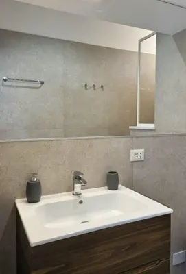 a bathroom with a white sink and a mirror at Sunshine Suite in Rome