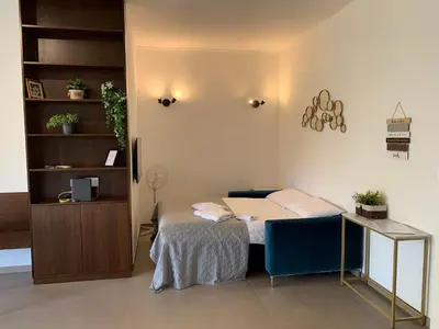 a small room with a bed and a desk at Sunshine Suite in Rome