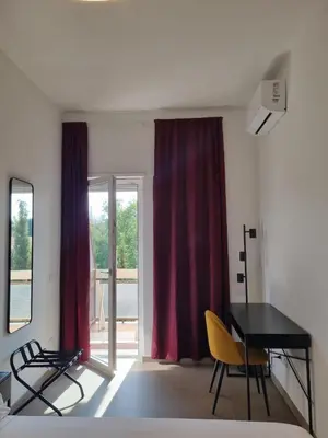 a room with a table and chairs and a red curtain at Sunshine Suite in Rome