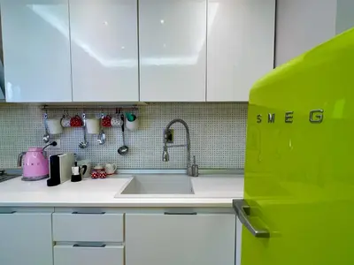 a kitchen with a sink and white cabinets at Alileo At The Vatican in Rome