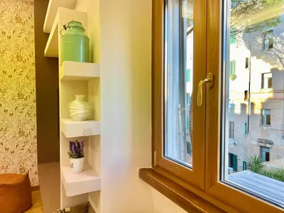 a window with white shelves next to a window at Alileo At The Vatican in Rome