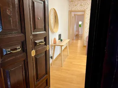a hallway with a door and a table in a room at Alileo At The Vatican in Rome