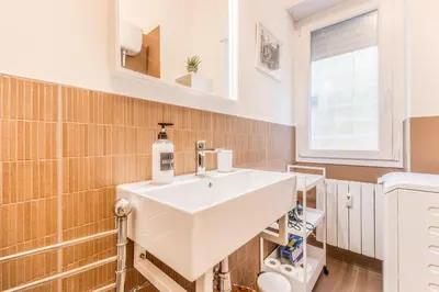 a bathroom with a sink and a toilet at Al 32C del Gianicolo in Rome