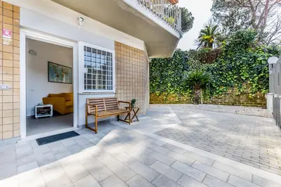 a patio with a bench and a building at Al 32C del Gianicolo in Rome
