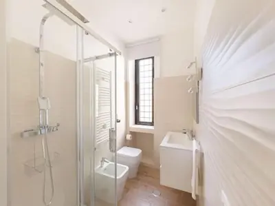 a bathroom with a shower and a toilet and a sink at Cozy & Chic Apartment - Piazza Bologna in Rome
