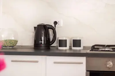 a coffee pot and two candles on a kitchen counter at Cozy & Chic Apartment - Piazza Bologna in Rome
