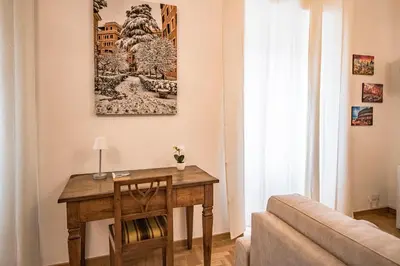 a living room with a wooden table and a painting on the wall at Esa apartment Flaminio in Rome