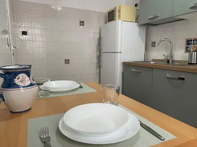 a kitchen with a table with a white plate on it at Interno 3 - Vatican Apartment in Rome