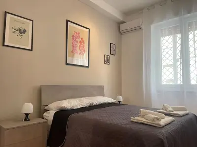 a bedroom with a bed with two towels on it at Interno 3 - Vatican Apartment in Rome