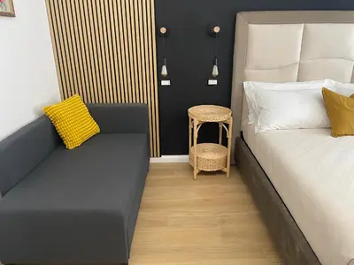 a bedroom with a bed and a stool next to a table at Wow Rome Home in Rome