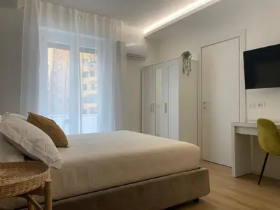 a bedroom with a large bed and a window at Wow Rome Home in Rome