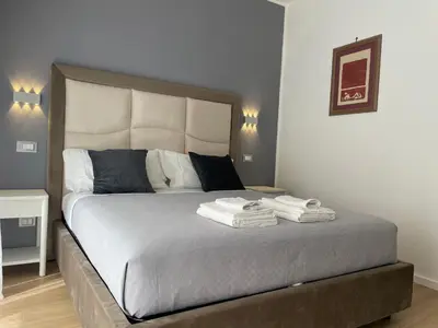 a bedroom with a large bed with towels on it at Wow Rome Home in Rome