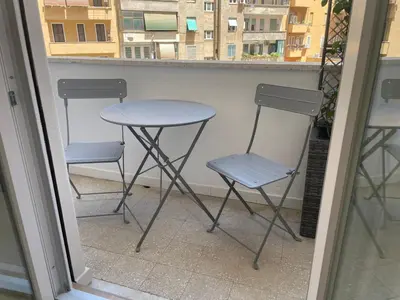 two chairs and a table on a balcony at Wow Rome Home in Rome
