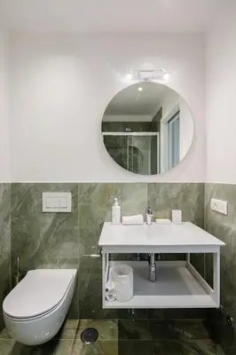a bathroom with a sink and a toilet and a mirror at Suite Lucrezio in Rome in Rome