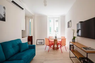 a living room with a blue couch and a table at Suite Lucrezio in Rome in Rome