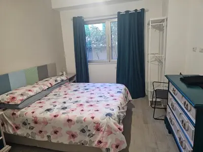 a bedroom with a bed and a dresser and a window at EMHouse in Rome