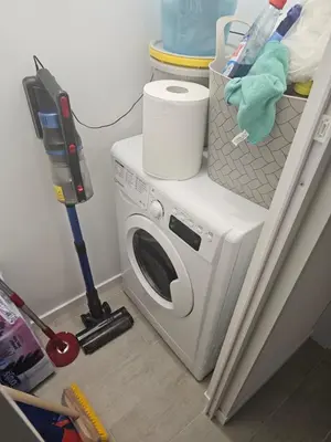 a washing machine in a room with a vacuum at EMHouse in Rome
