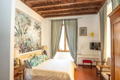 a bedroom with a bed and a painting on the wall at Antuela Pantheon in Rome