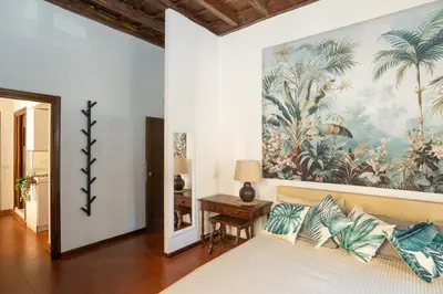 a bedroom with a bed with a painting on the wall at Antuela Pantheon in Rome