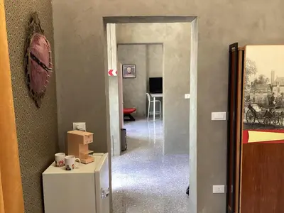 a hallway with a door leading into a room at casa galleria d'arte in Rome
