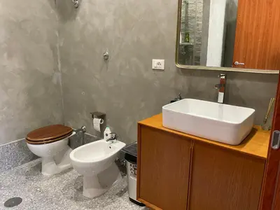 a bathroom with a sink and a toilet and a mirror at casa galleria d'arte in Rome