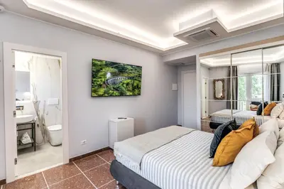 a bedroom with two beds and a bathroom at 3Storie Vatican St Peter in Rome