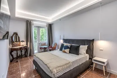 a bedroom with a large bed and a desk at 3Storie Vatican St Peter in Rome