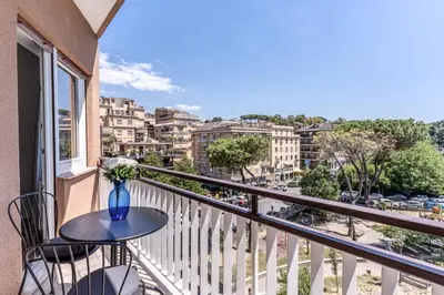 a balcony with a table and chairs and a view of a city at 3Storie Vatican St Peter in Rome