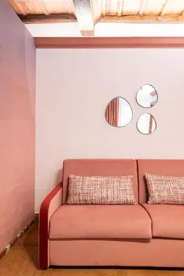 a living room with a couch and two mirrors at My Trevi Suite & Apartment in Rome