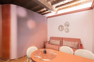 a room with a couch and a table and chairs at My Trevi Suite & Apartment in Rome