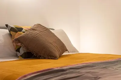 a bed with a pillow on top of it at Porta Pia - cozy flat in Rome