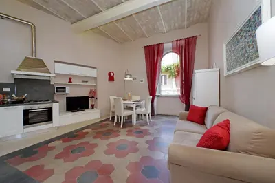 a living room with a couch and a kitchen with a table at dolce casa colosseo 1 - 2 in Rome